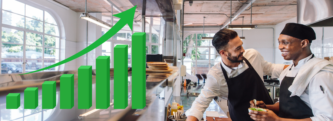 Chefs in a professional kitchen with an increasing productivity graph