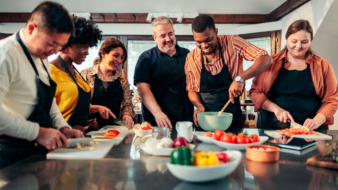 Students at a cooking school chopping ingredients